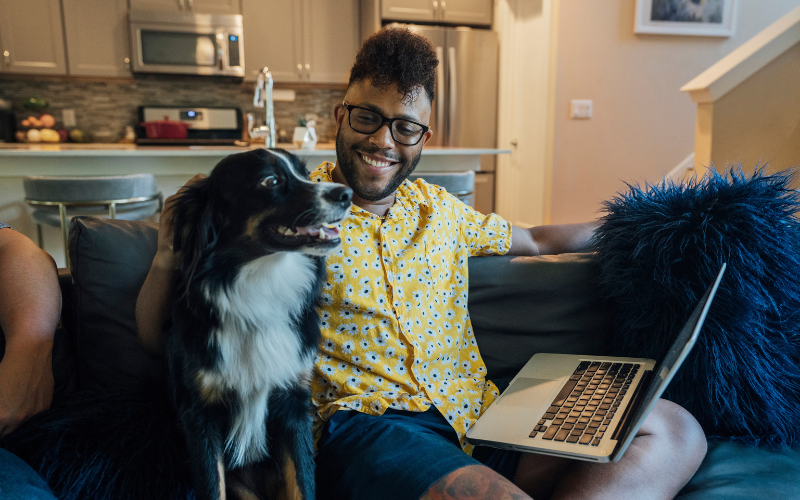 Happy man and his dog at home